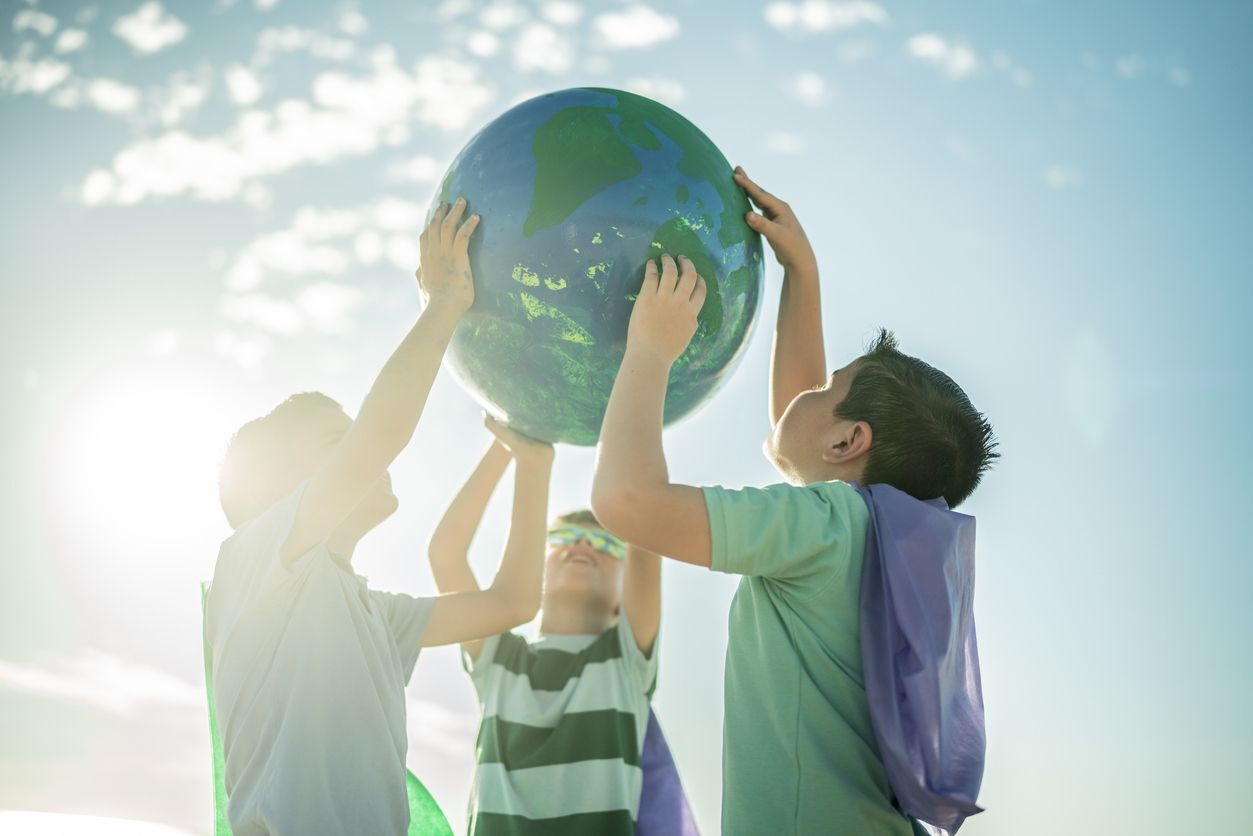 3 boys holding a planet earth ball