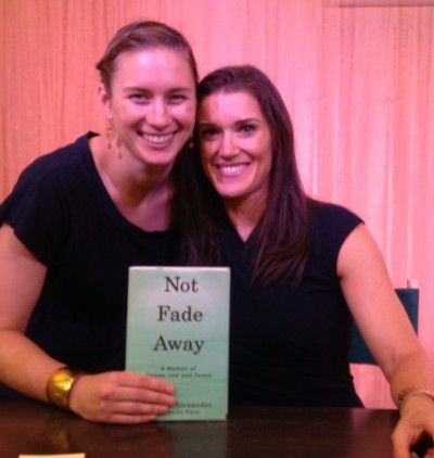 Caroline and Rebecca at book signing. The book is titled Not Fade Away