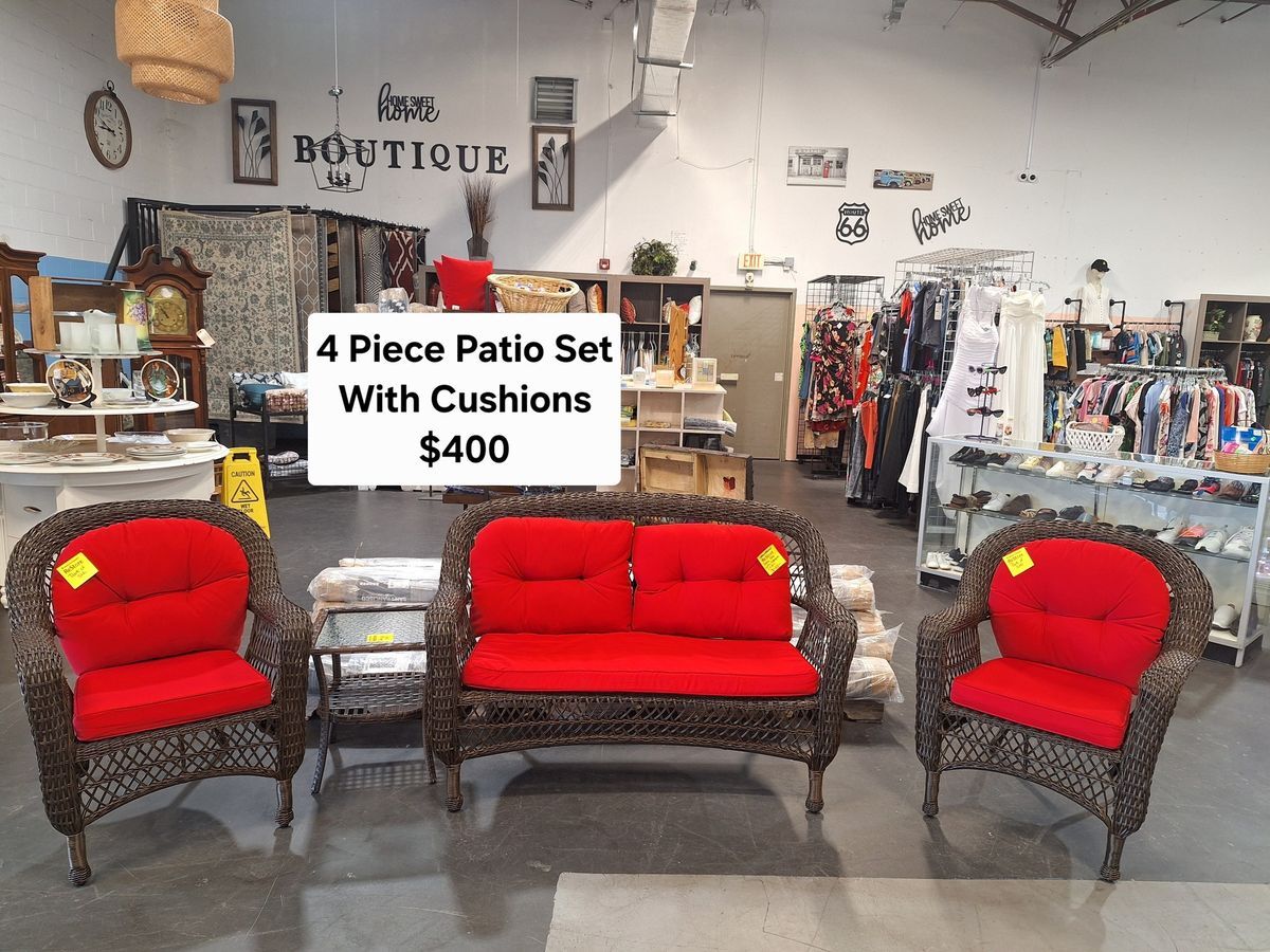 Four-piece outdoor wicker patio set with bright red cushions available at Habitat ReStore Zephyrhills – $400