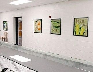 School serving line wall with nutrition education, 4 food posters in frames, watercolor style