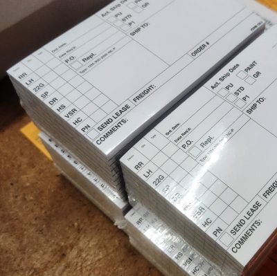 Wrapped packages of order slips printed for Butler Manufacturing.