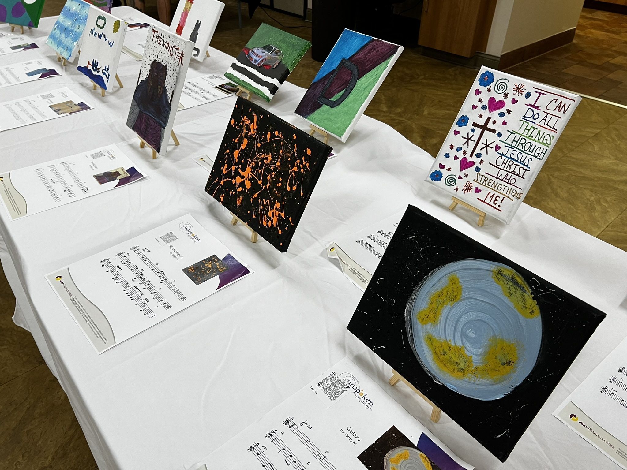 A woman stands smiling next to a woman sitting in a wheelchair, also smiling.  They are holding hands.