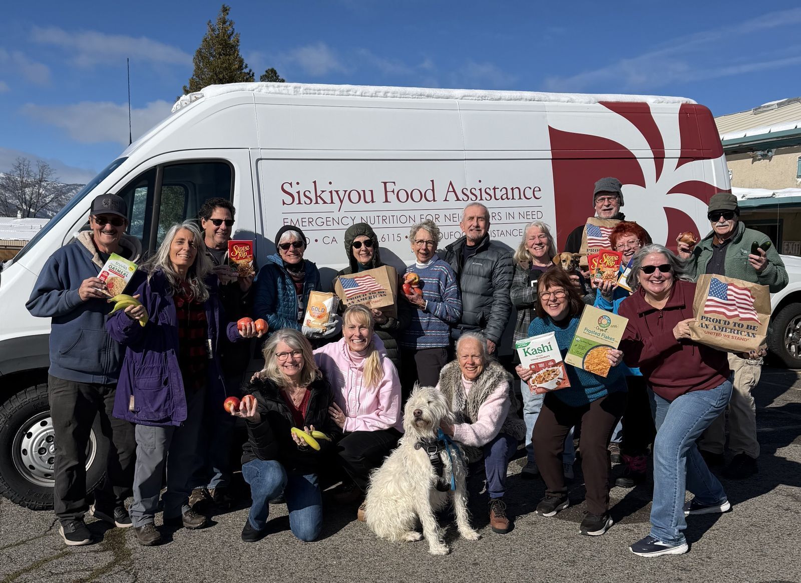 Group of volunteers with dog infront of sfa van