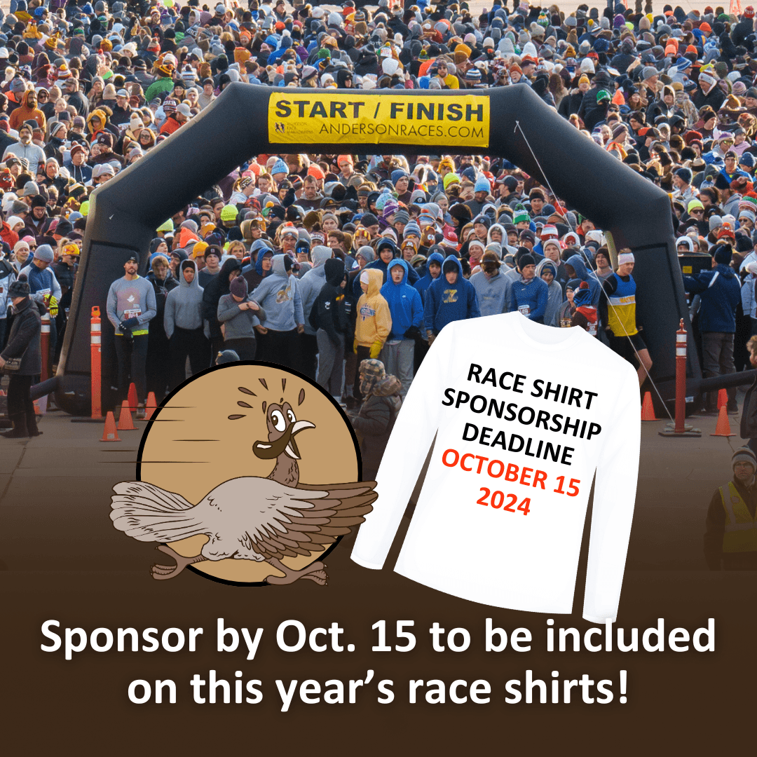 Overhead photo of crowd of runners behind the inflatable race start line with graphic of race shirt and text sponsor by october 15 to be include don this year's race shirts