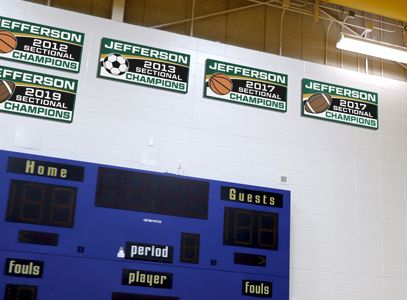 School gym with championship banner boards, school signage company, custom signs