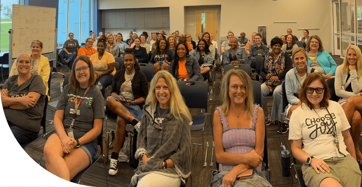 educators sitting in chairs in a library