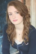 Kiera Allen. A woman who is in her 20's and she has brown hair. She is wearing a blue shirt and a neckless, and she’s posing for the picture.