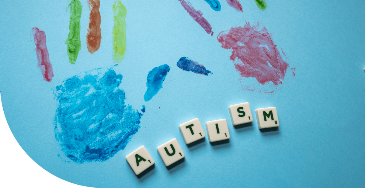 painted handprints and tiles spelling autism