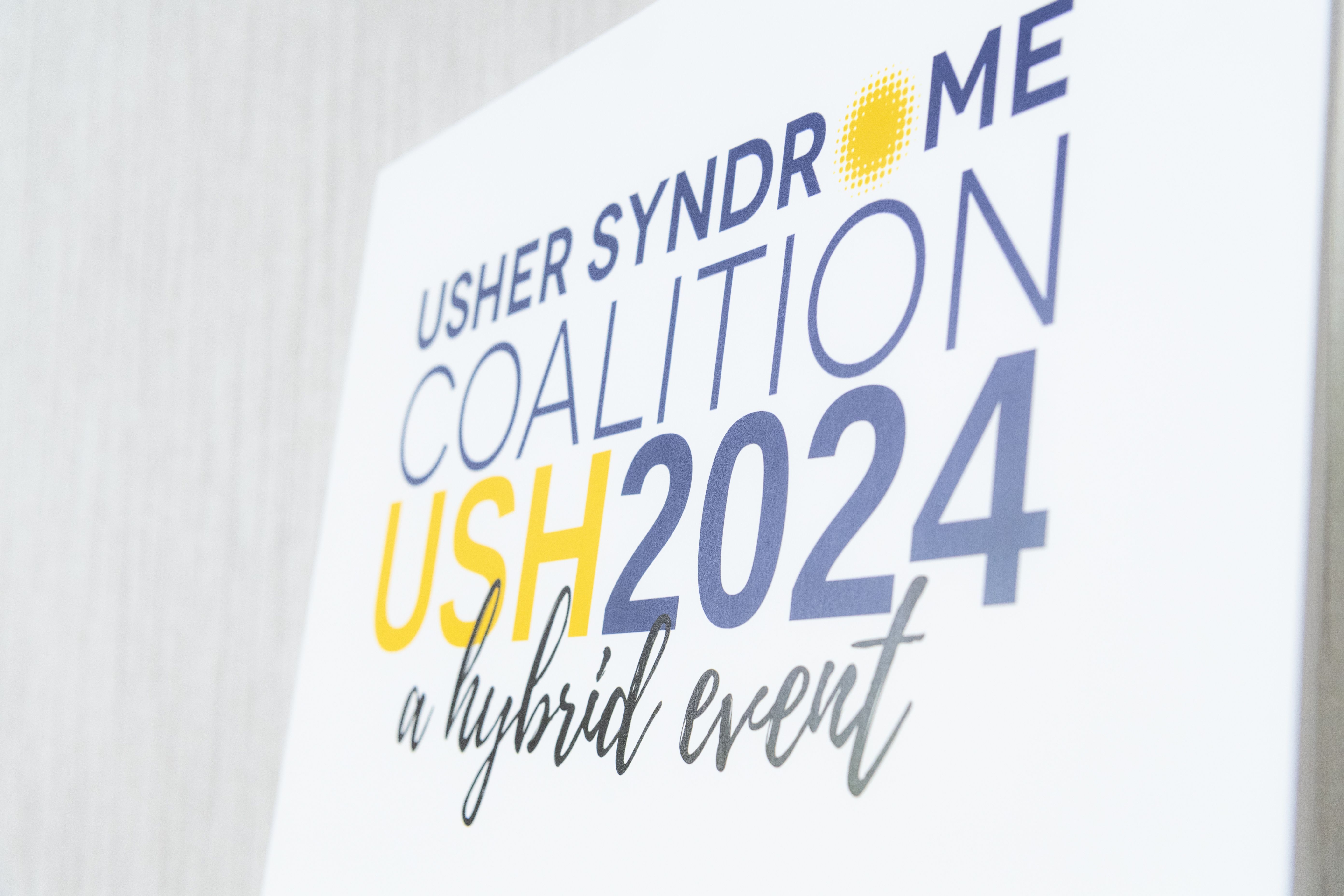 Angled view of a sign displaying USH2024, a hybrid event