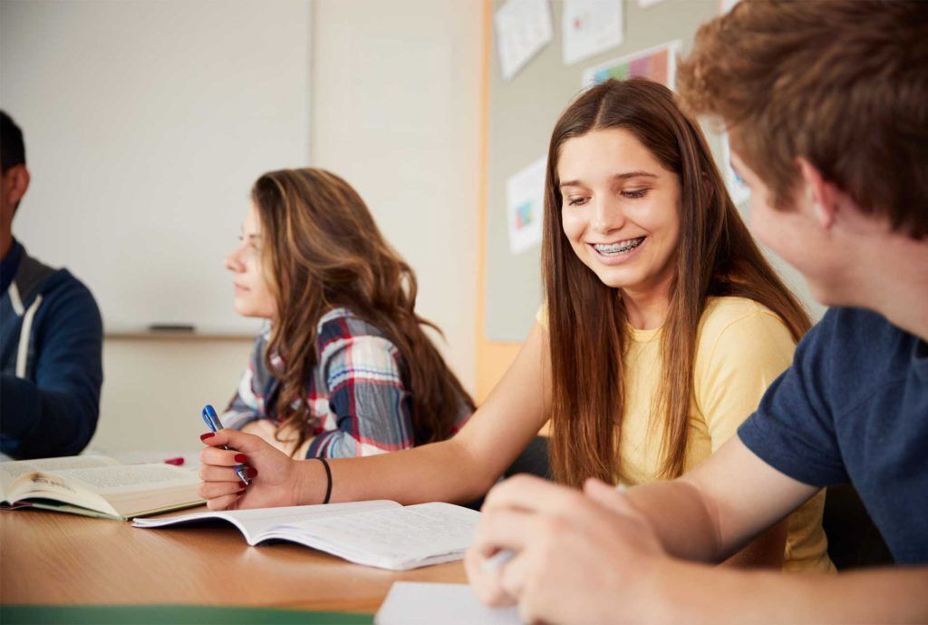 Photo of students working on homework in class. 