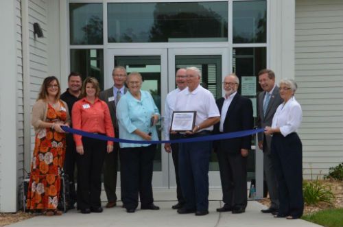 Judy Jasper cuts the ribbon for the Educational Center