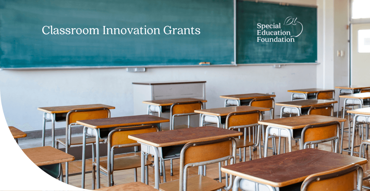classroom with desks and chalkboard with Classroom Innovation Grants on it