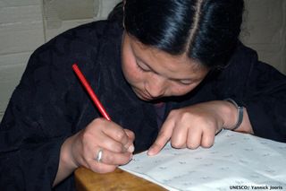 Woman learning to read and write in English