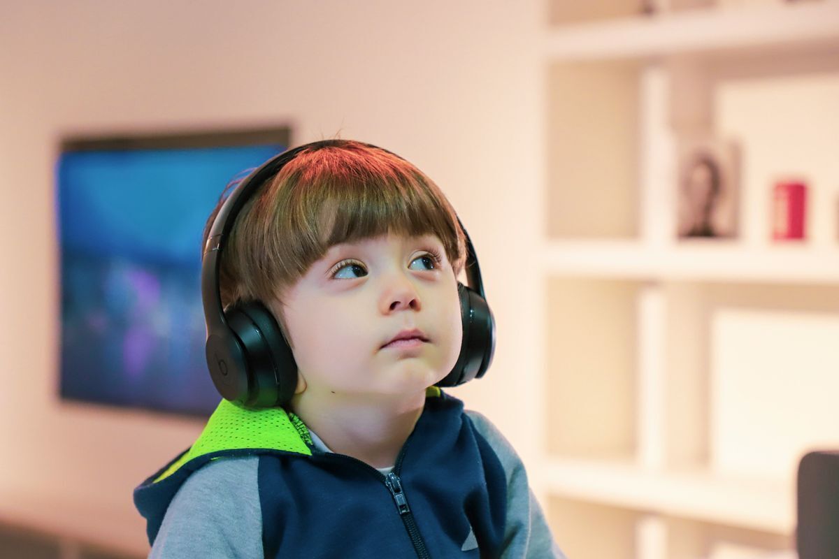Child listening to headphones