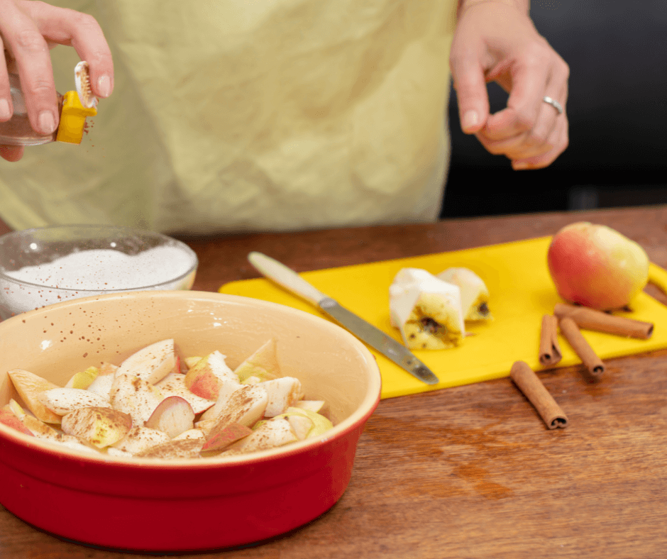 Hands cooking with apples and spices