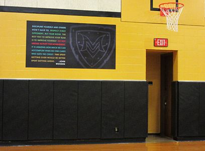 School gym with motivational saying with school logo, large custom signs