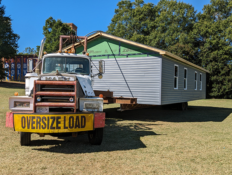 The completed 2023 Homecoming House perched on a truck and ready to leave Bowman Field