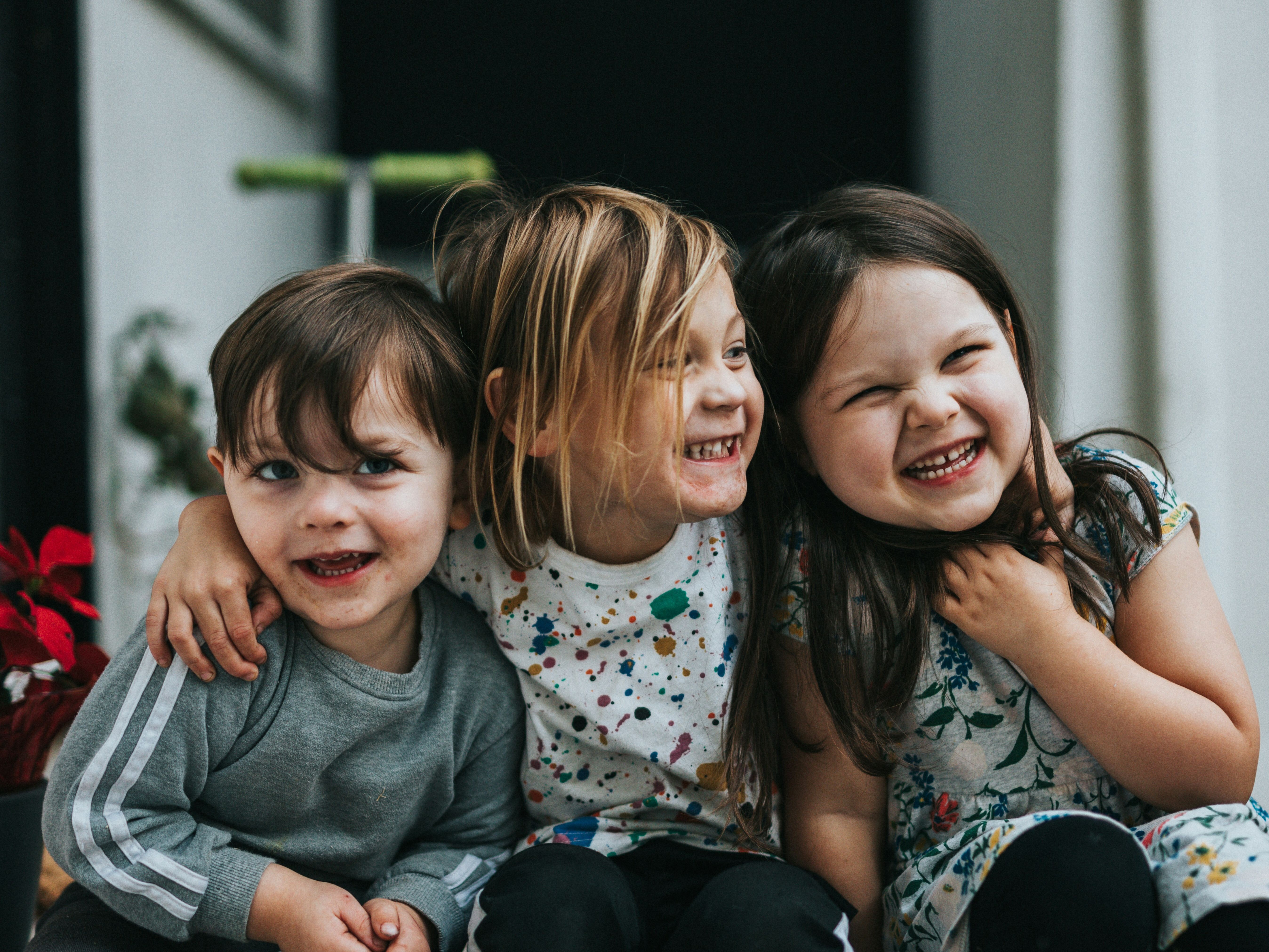 Three kids laughing.