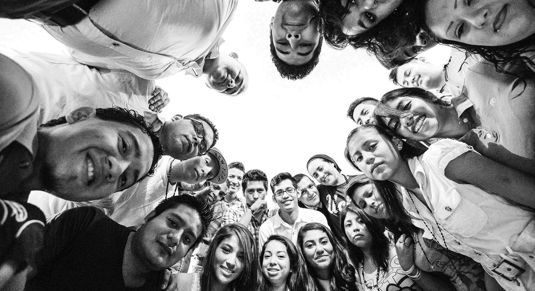 Several youth huddled in a circle.