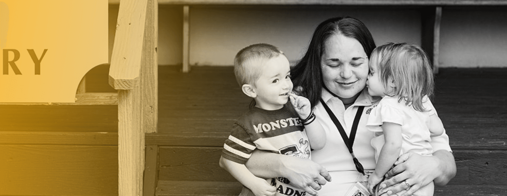Black and white image of a women holding two young babies