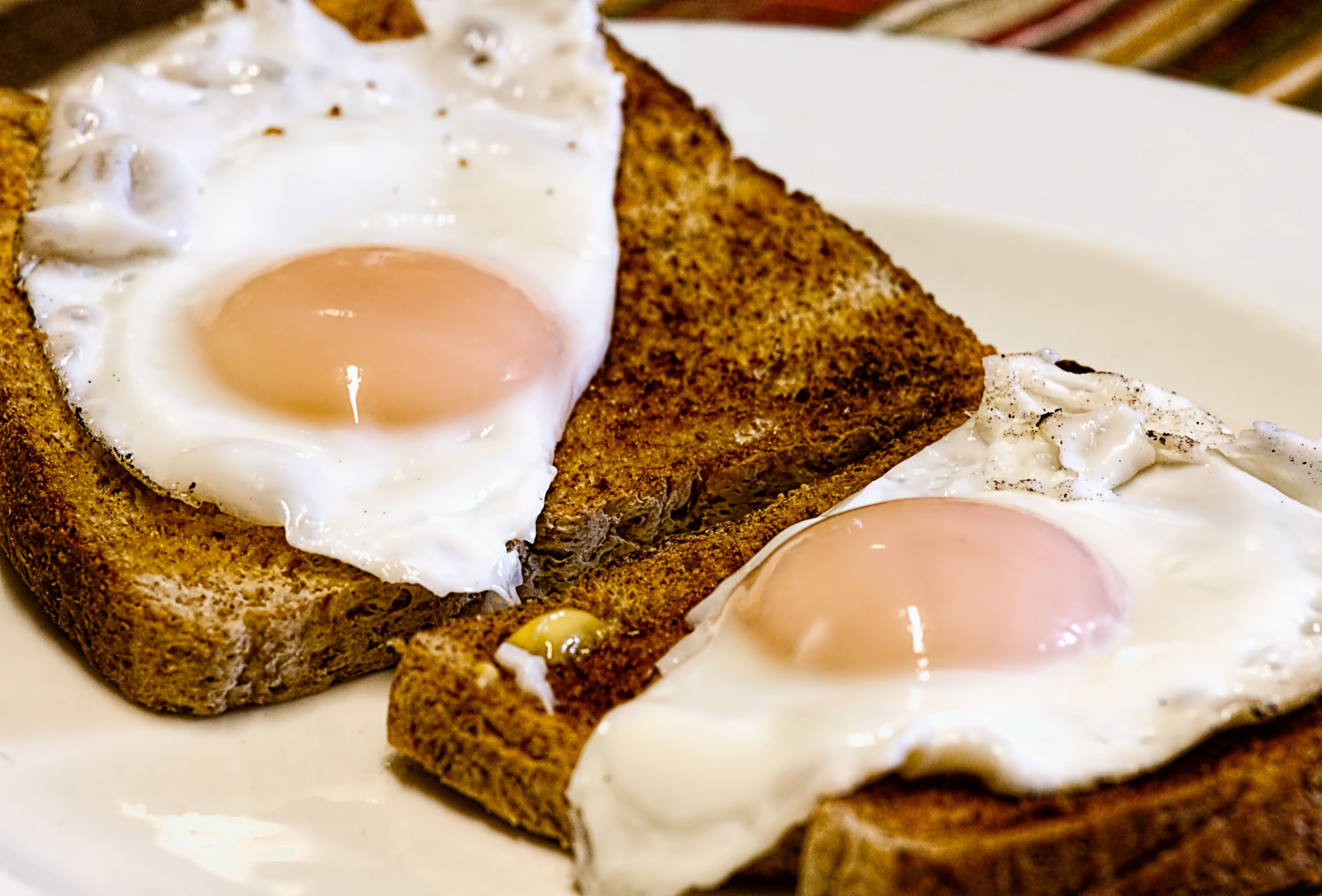 Two sunny side up eggs on pieces of toast