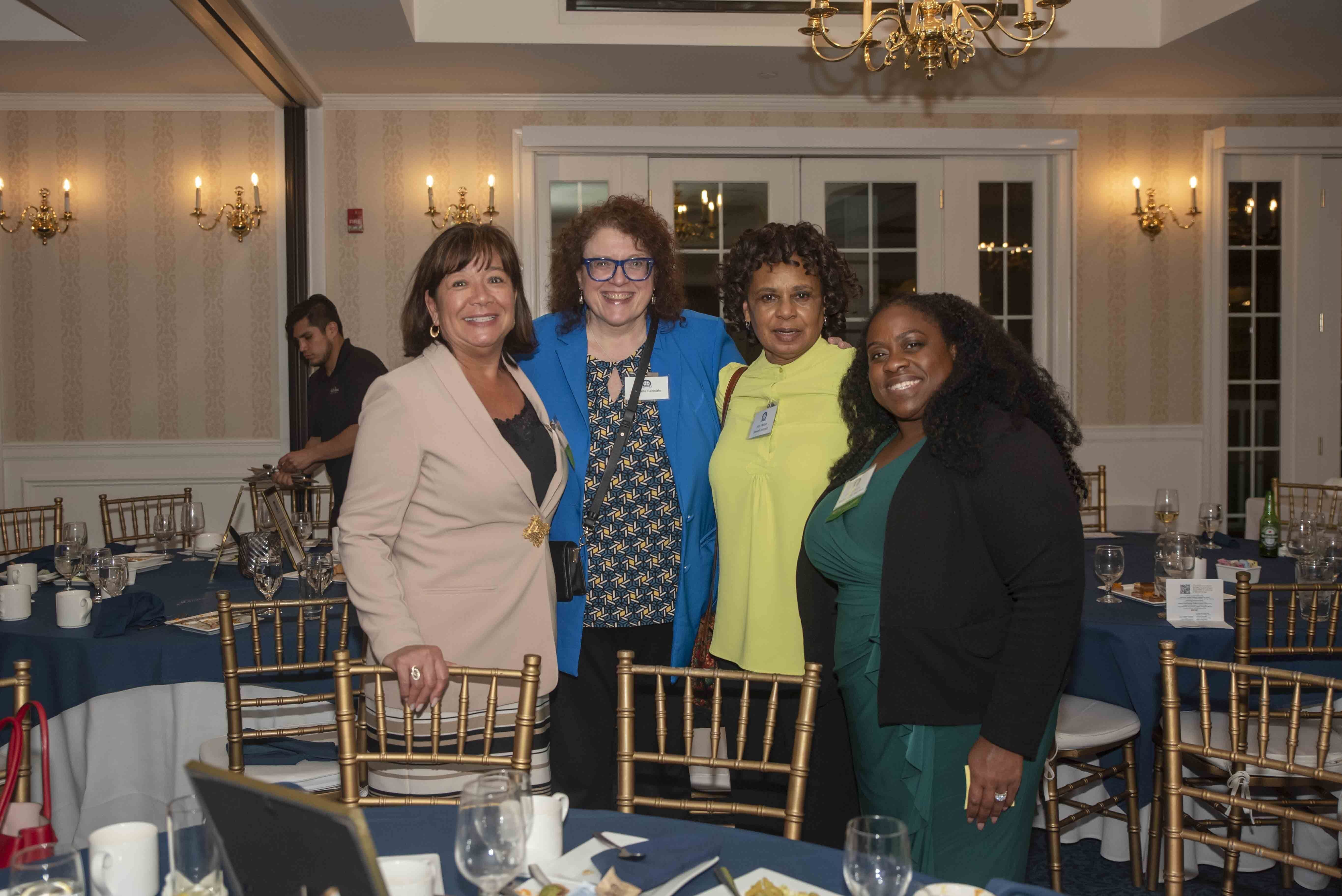 Image of four women, attorneys and Fellows members, inside at the Annual Reception