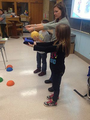 Teacher working with two students.