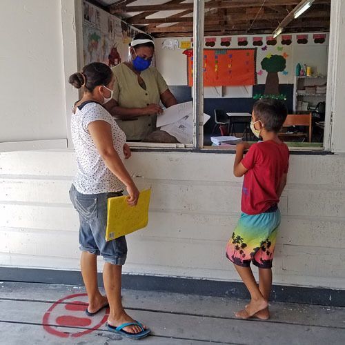 Woman and child registering for school.