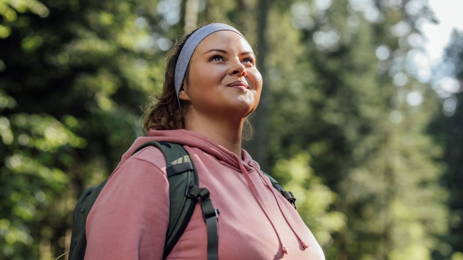 Woman wearing backpack standing in nature