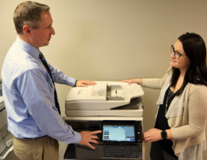 Man Talking with Woman at Copier