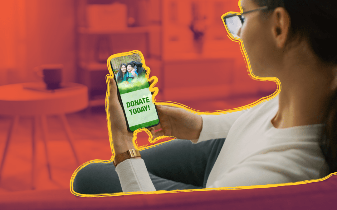 Person holding phone with 'Donate Today' graphic