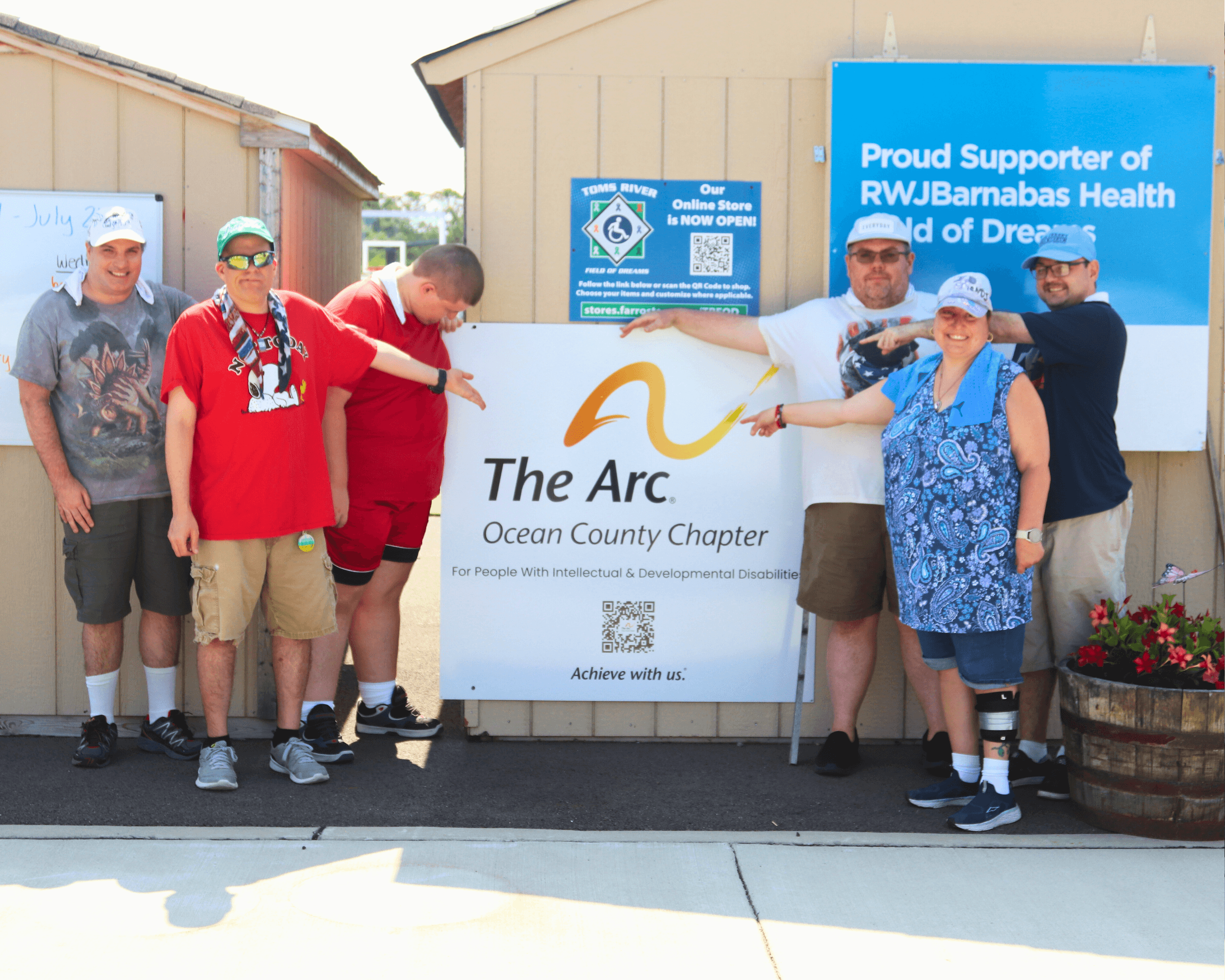 Vocational participants pose with Arc Ocean sign at the Field of Dreams