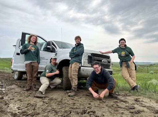 A crew poses next to an MCC rig.