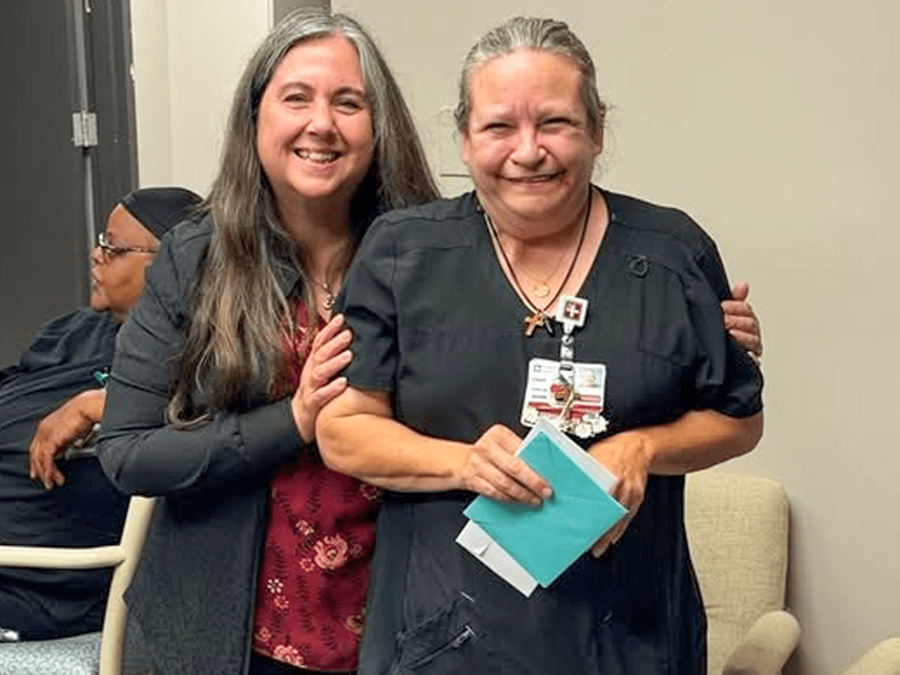 woman recieving award from colleague