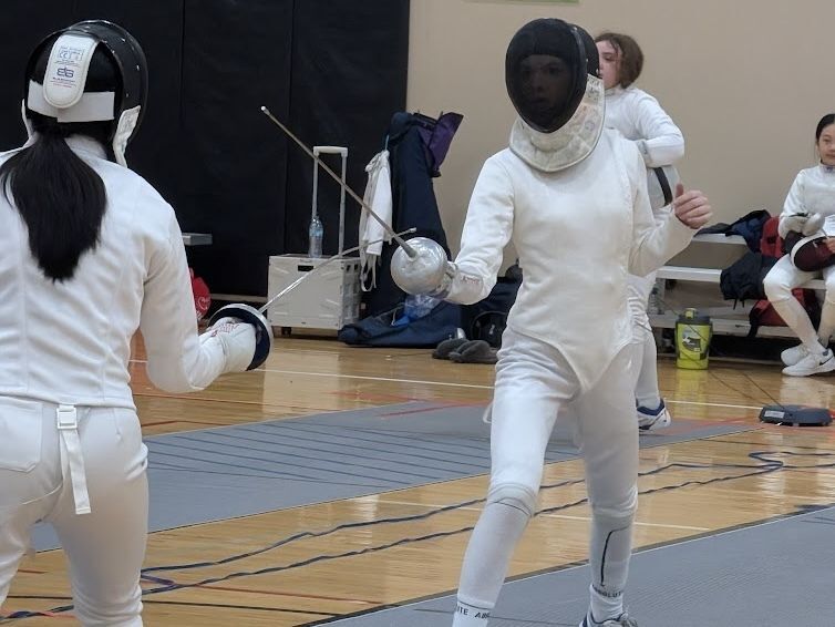 Two female epee fencers square off