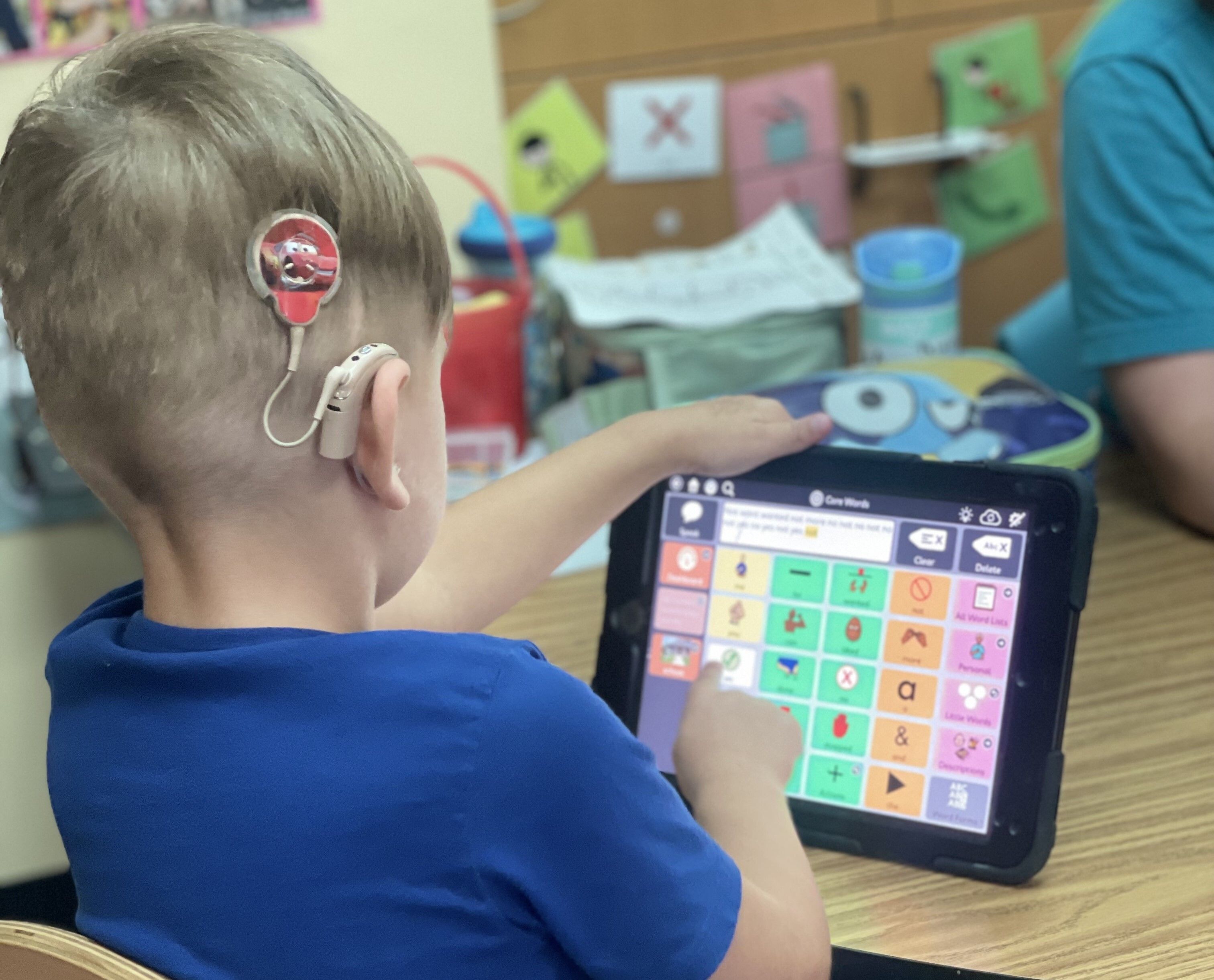 Sound Plus student using AAC on tablet to communicate