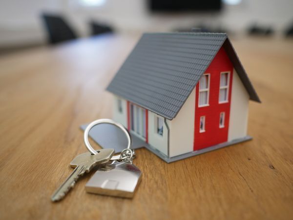 Model home on table with keychain