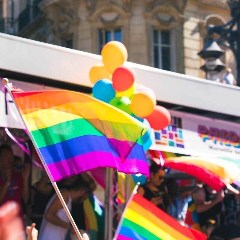 Rainbow flags and colorful balloons.