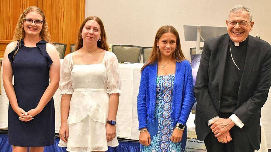 The Father Clem Hammerschmitt high school scholarship awards were presented by Bishop Gerald M. Barbarito to three young women for their outstanding achievements and dedication to their parishes who will be attending Catholic high schools in the fall.