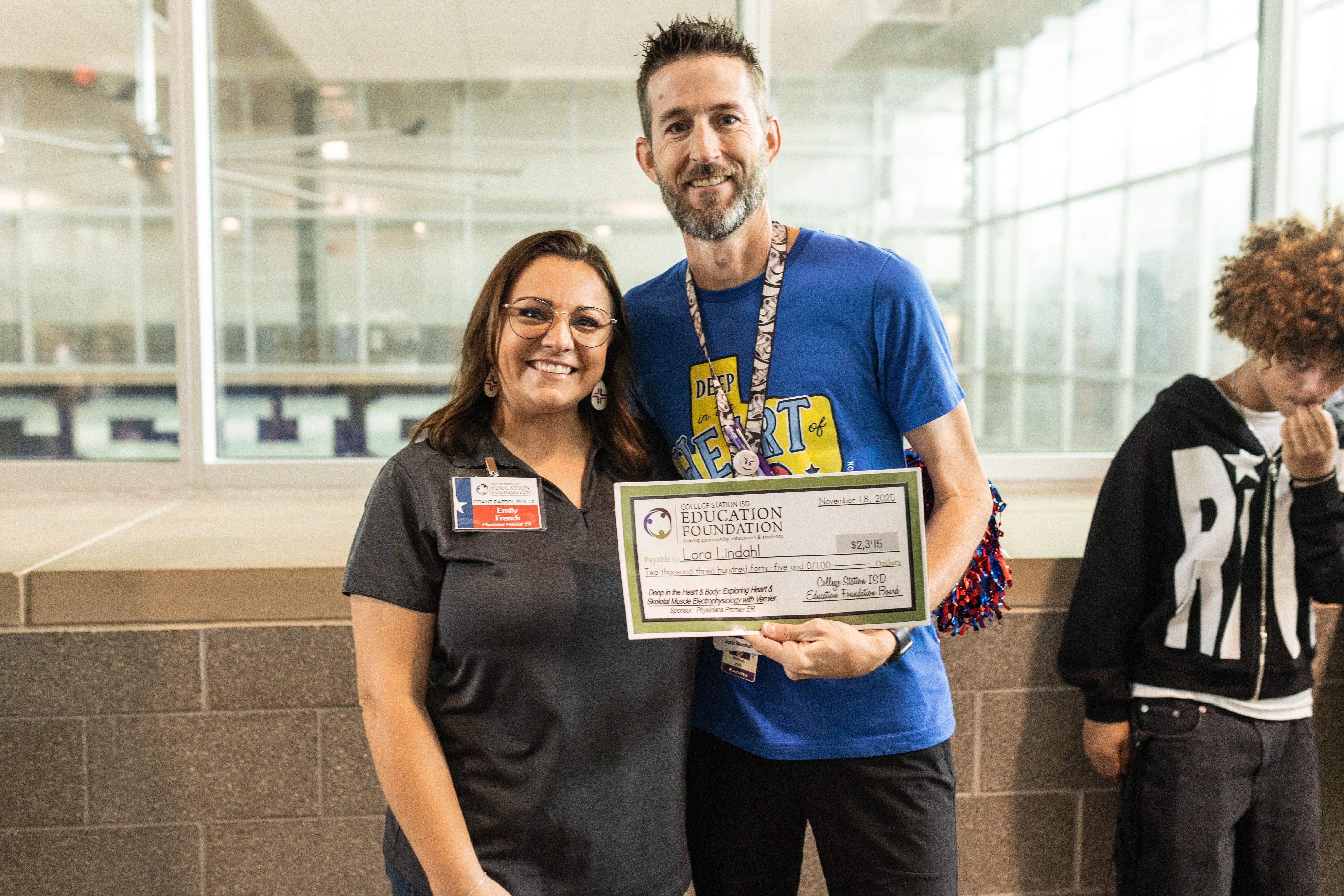 Teacher receives grant check from communtiy donor
