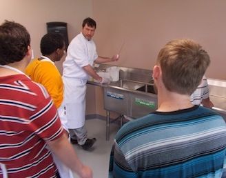 Chef Scott demonstrating kitchen safety measures