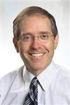 Photo of Dr. Josh Korzenik wearing a tie, smiling at the camera