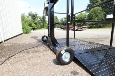 Affordable Wheelchair lift that has two wheels from the Wheel Kit installed on the base of the lift.