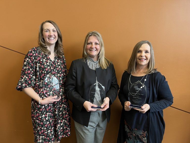 Teachers showing their awards.