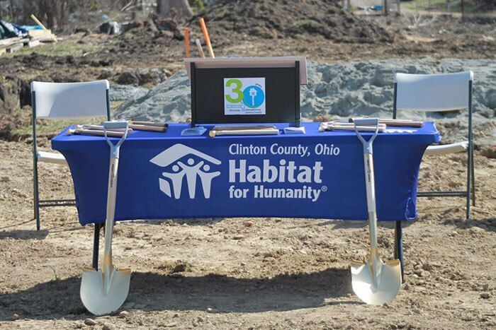Table with Habitat cloth and shovels for groundbreaking ceremony.