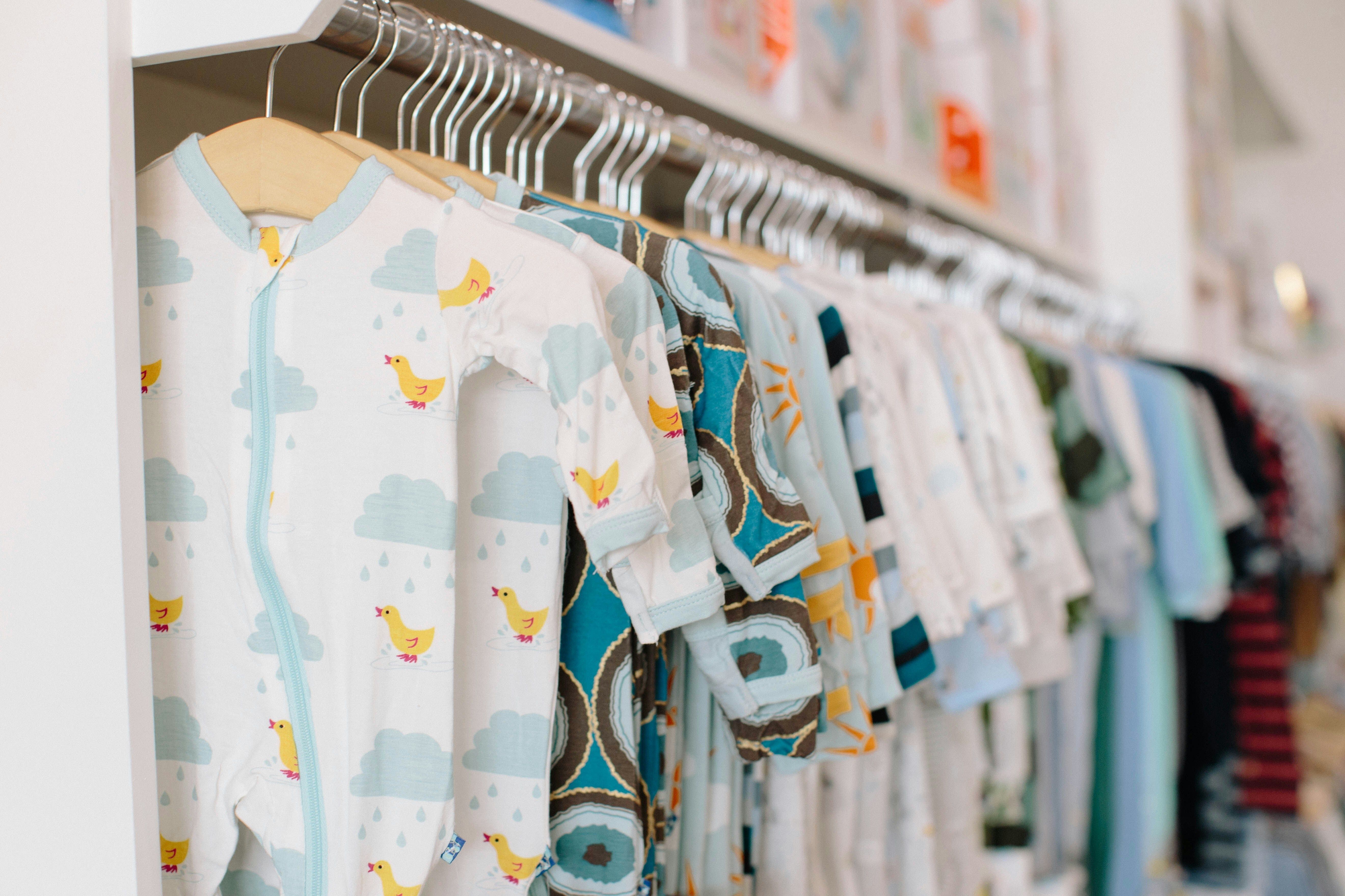 Photo of baby clothes hanging up.