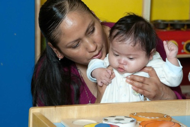 Infant with Down syndrome at therapy for early intervention.