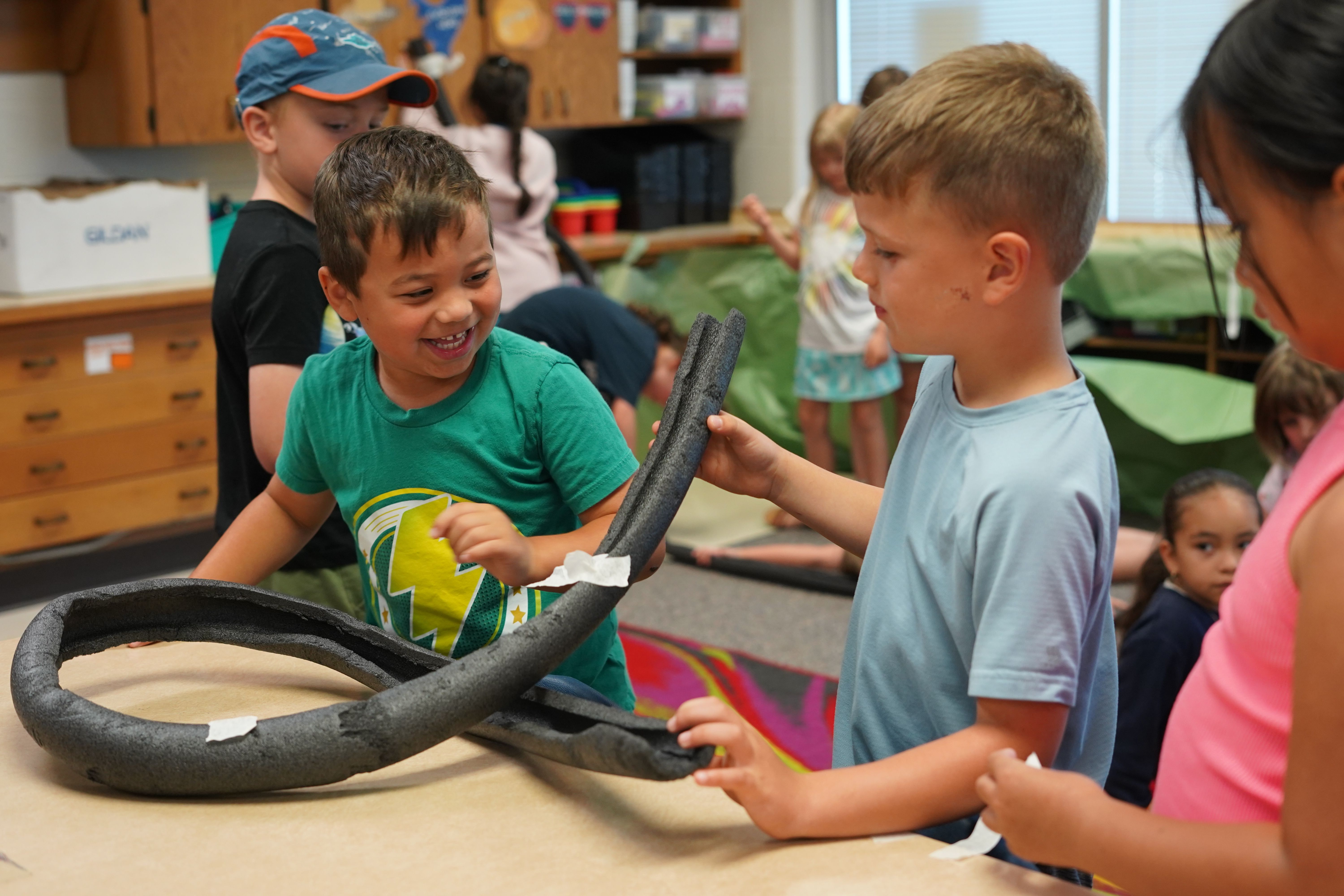 Camp counselor and student looking into body of water 