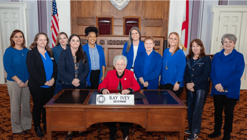 Child Trafficking Solutions Project and other state organizations stand beside Gov. Kay Ivey for signing of Human Trafficking Awareness Month Proclamation