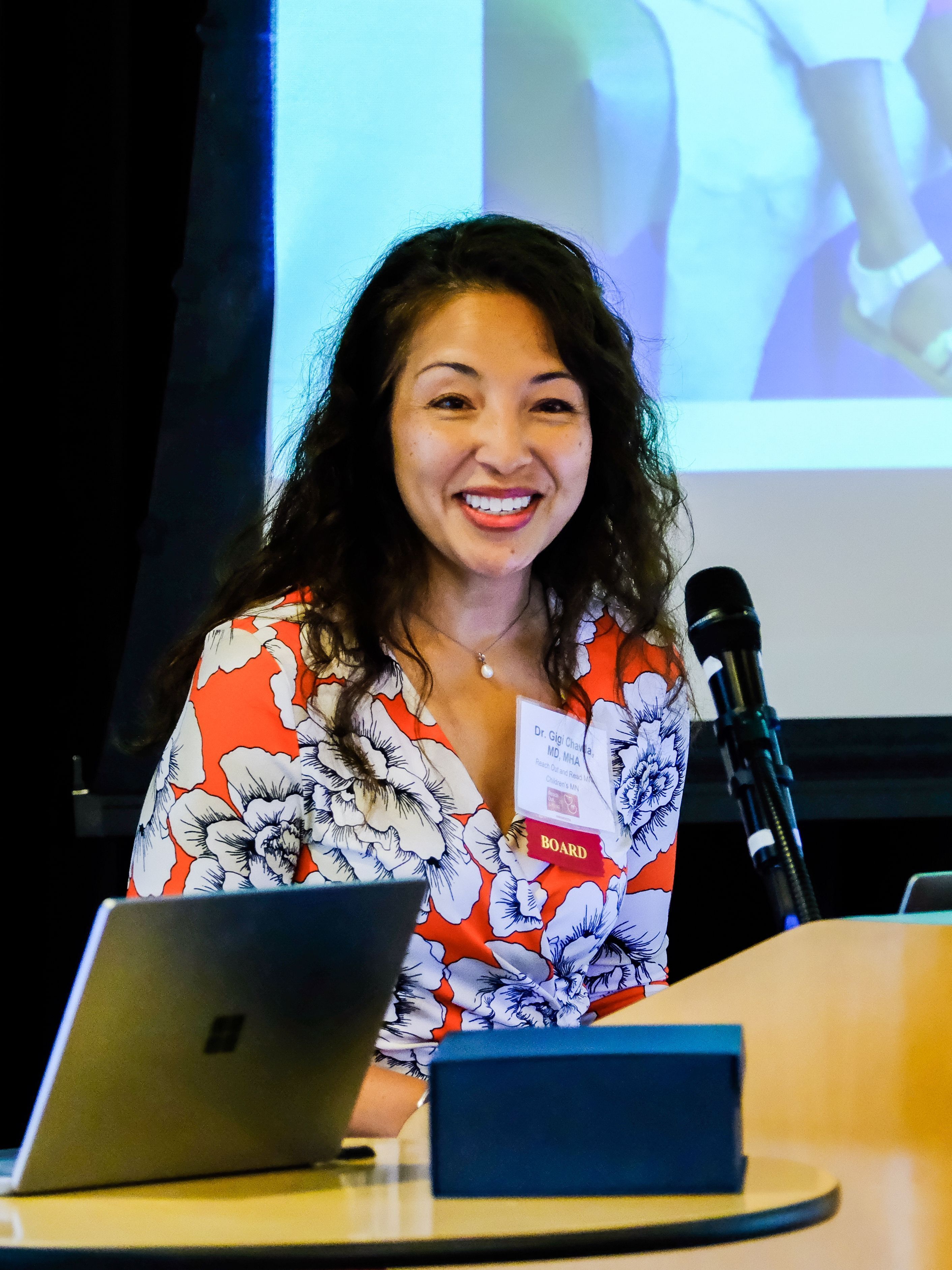 Woman smiles at podium